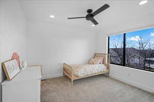 Bedroom with a ceiling fan, recessed lighting, light carpet, and baseboards