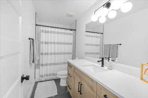 Full bathroom featuring tile patterned flooring, visible vents, vanity, and toilet