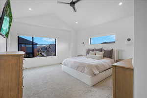 Bedroom featuring vaulted ceiling, multiple windows, recessed lighting, and light colored carpet