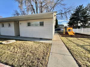 Exterior space with a https://www.utahrealestate.com/lip/photo/listno/2068740#yard, crawl space, a playground, and fence