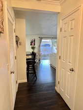 Corridor with baseboards and dark wood-type flooring