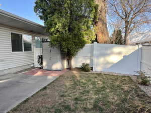 View of yard featuring a fenced backyard and a patio