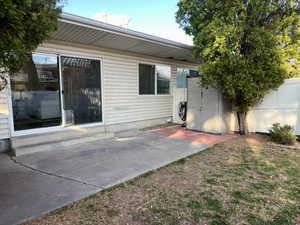 Rear view of house featuring a patio and fence