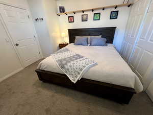 Carpeted bedroom featuring baseboards