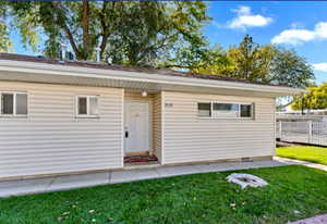 View of front of property with crawl space and a front lawn