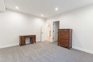 Carpeted basement bedroom with closet.