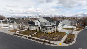 Traditional-style home featuring driveway, covered porch, a residential view, and a mountain view