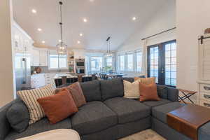 Living room featuring vaulted ceiling, french doors, and recessed lighting