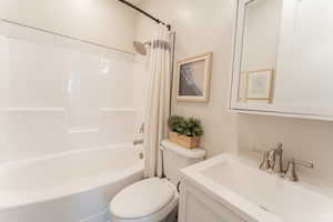 Full bathroom featuring shower / bath combination, vanity, and toilet