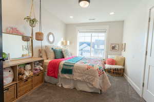 Carpeted bedroom 1 with french doors.