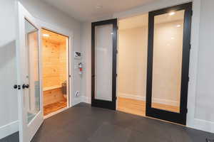 Exercise room featuring the sauna and french doors leading to the hall way.