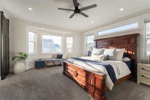 Owner’s suit! Large bedroom with carpet, large windows, recessed lighting, and a tasteful fan.