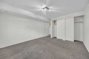 Unfurnished bedroom featuring two closets, carpet floors, baseboards, and visible vents