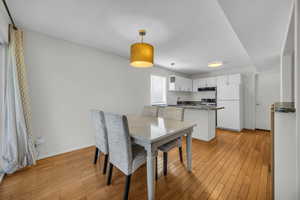 Dining area with light wood finished floors and baseboards