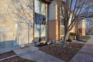 Entrance to property with brick siding