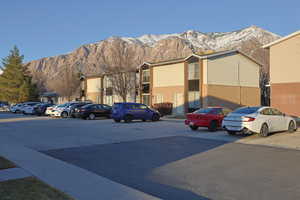 View of building exterior featuring uncovered parking and a mountain view