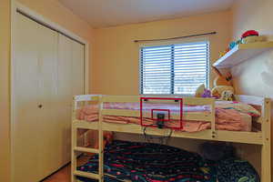 Bedroom with a closet and wood finished floors