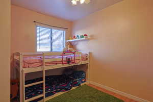 Bedroom featuring wood finished floors and baseboards