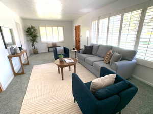 Living room with carpet floors and baseboards