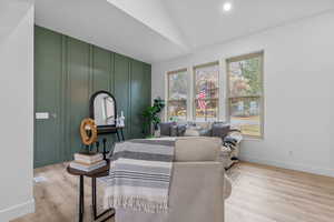 Interior space featuring light wood-style floors, visible vents, baseboards, and vaulted ceiling