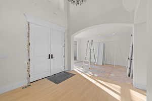 Foyer entrance with arched walkways, and high ceiling