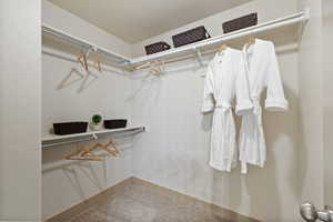 Walk in closet with carpet flooring
