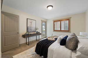 Bedroom with carpet floors, access to outside, and baseboards