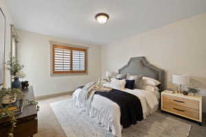 Bedroom with carpet flooring and baseboards