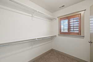 Walk in closet featuring carpet floors and visible vents