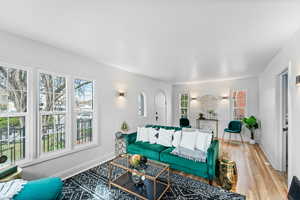 Living room with light wood-style flooring and baseboards