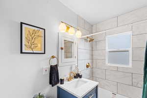 Bathroom with a tile shower and vanity