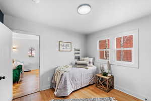 Bedroom with light wood finished floors and baseboards