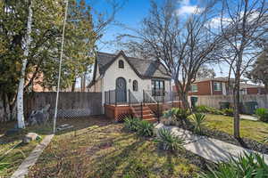 View of front of house featuring fence private yard, brick siding, and a deck