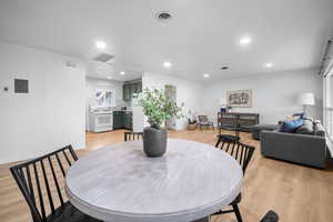 Dining area with LVP flooring and recessed lighting