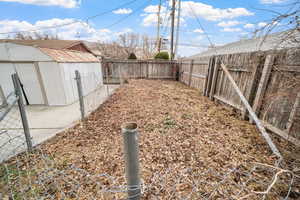 View of side yard with shed and large garden area