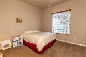 Bedroom featuring carpet, visible vents, and baseboards