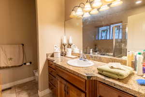 Bathroom featuring visible vents, toilet, a stall shower, vanity, and tile patterned flooring