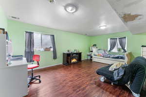 Bedroom featuring baseboards, and wood finished floors