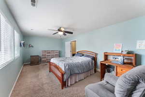 Bedroom with baseboards, ceiling fan, and light colored carpet