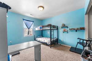 Bedroom featuring carpet and baseboards