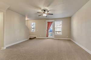 Unfurnished room with carpet flooring, ceiling fan, and baseboards