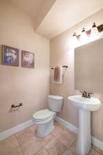 Bathroom with toilet and tile patterned floors