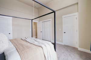 Carpeted bedroom featuring baseboards