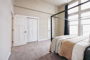 Carpeted bedroom with multiple closets and baseboards