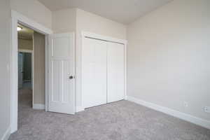 Unfurnished bedroom with carpet floors and a closet