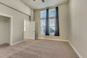 Unfurnished bedroom featuring baseboards, visible vents, and light colored carpet