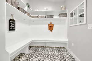 Mudroom featuring baseboards and tile patterned floors