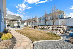 View of yard featuring a residential view, a patio area, a fenced backyard, and an outdoor structure