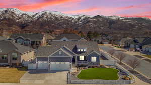 Exterior space with a fenced front yard, a residential view, a mountain view, and a lawn