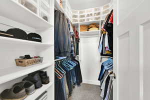 Walk in closet featuring carpet flooring